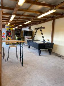 una stanza con tavolo da ping pong e pianoforte di camping du ried à proximité d'Europa-Park et Rulentica a Boofzheim