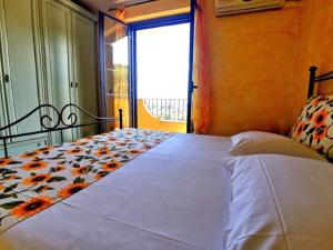 ザンブローネにあるBaciati dal Soleのベッドルーム1室(花の毛布付きのベッド1台付)