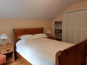 a bedroom with a large white bed with two pillows at Comfy Stay - Close to Everything in Halifax