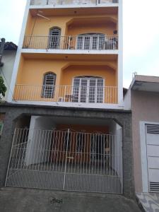 an apartment building with a balcony and a garage at Santo Ivo in Aparecida