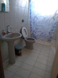 a bathroom with a sink and a toilet and a shower at Santo Ivo in Aparecida