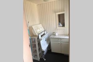 a kitchen with a sink and a table with a mirror at Lejlighed ved Kongeåen in Ribe