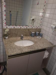 a bathroom counter with a sink and a mirror at Beach Class Muro Alto Porto de Galinhas in Porto De Galinhas