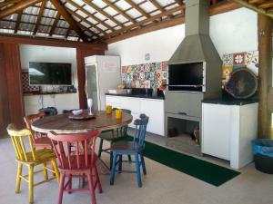 a kitchen with a table and chairs and a stove at Pousada da Preguiça Praia do Forte in Praia do Forte