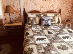 a bedroom with a bed with a bear quilt at Wrangell Mountain Lodge- Private Bathroom with shower in McCarthy
