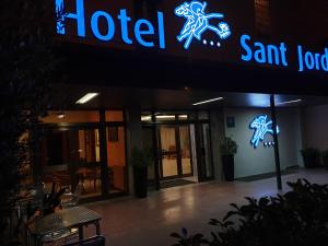 a restaurant with a sign on the side of a building at Hotel Sant Jordi in Tarragona