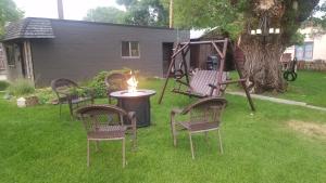 a group of chairs and a table with a candle at Secret Cottage Yellowstone 1 bd 2 beds dtwn #1 in Cody