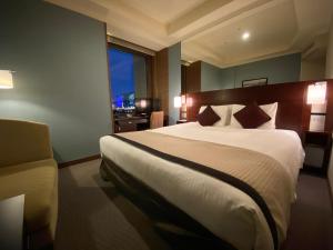 a hotel room with a large bed and a window at Hotel Trusty Tokyo Bayside in Tokyo