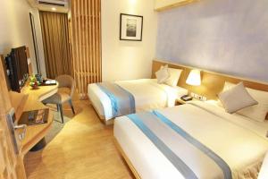 Postel nebo postele na pokoji v ubytování Liberta Hotel Jimbaran