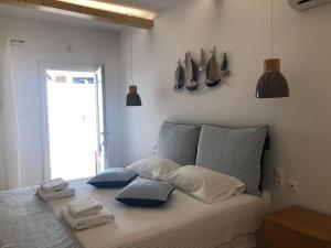 a bedroom with a bed with towels on it at Karidis Hotel in Kamari