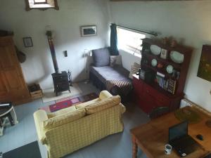 a living room with a couch and a table at Druid cottage in Glendree
