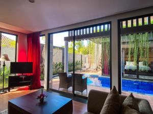 a living room with a view of a pool at Puri Hiromi Boutique Residence in Sanur