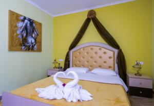 a bedroom with a bed with towels on it at Paradice Hotel Luxury Suites-Near zorbas Beach-FREE Breakfast in Stavros