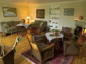 a living room with a couch and a fireplace at Rundhaug Gjestegard in Rundhaug
