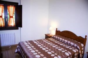 Uma cama ou camas num quarto em Apartamentos La Catedral