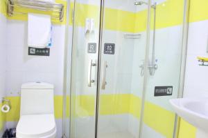 a bathroom with a shower and a toilet and a sink at 7Days Inn Guangzhou Tianhe Yantang Yue Ken Road in Guangzhou