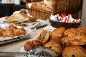 a table with various types of pastries and bread at Grand Palace Hotel Hannover in Hannover