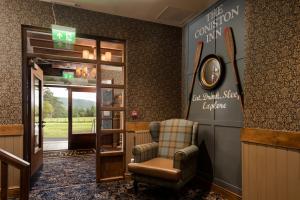 a waiting room with a chair and a sign on the wall at The Coniston Inn - The Inn Collection Group in Coniston