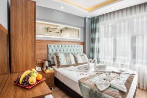 a bedroom with a bed with a bowl of fruit on a table at Istanbul Sirkeci Hotel in Istanbul