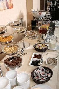 a buffet with many different types of food on a table at Grand Palace Hotel Hannover in Hannover