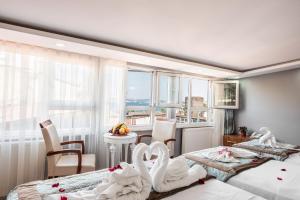 a bedroom with two beds and a table with chairs at Istanbul Sirkeci Hotel in Istanbul