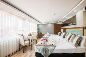 a bedroom with a large bed with a table and chairs at Istanbul Sirkeci Hotel in Istanbul