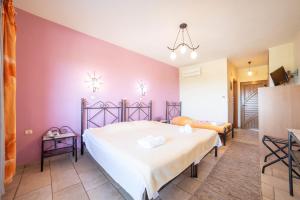 Postel nebo postele na pokoji v ubytování Hotel Erodios