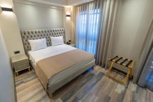 Ένα ή περισσότερα κρεβάτια σε δωμάτιο στο Mardia Hotel