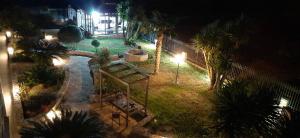 an aerial view of a garden at night at The Villa of the Winds in Néa Kíos