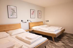 two beds in a room with two at ART Hostel & Apartments in Dvůr Králové nad Labem