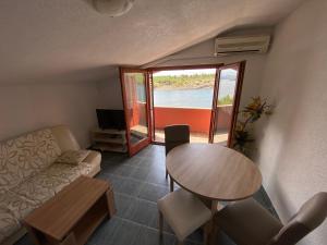 a living room with a table and a couch at Misho Apartments in Kruševo