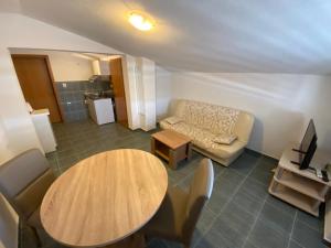 a living room with a table and a couch at Misho Apartments in Kruševo