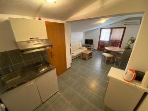 a kitchen and living room with a couch and a table at Misho Apartments in Kruševo
