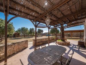 an outdoor patio with a table and chairs at Finca Santa Maria Magdalena in Ciutadella