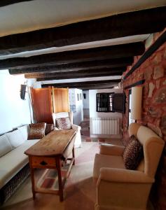 a living room with couches and a table in a building at Casa Rural Bracamonte in Alcaraz