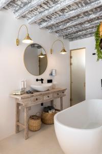 a bathroom with a sink, toilet and tub at The TownHouse Mykonos in Mýkonos City