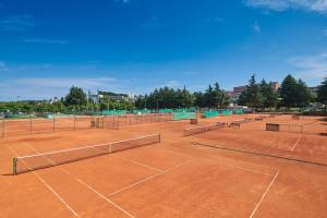 a tennis court with several tennis nets on it at Hotel Zorna Plava Laguna in Poreč