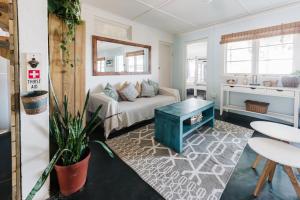 a living room with a couch and a table at Umzumbe Surf House in Umzumbe