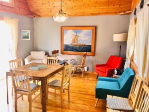 a living room with a wooden table and chairs at Valhalla near L'Anse aux Meadows in L'Anse aux Meadows