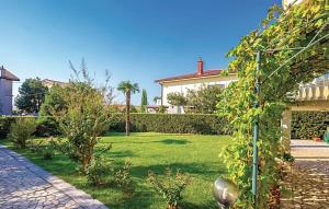 a house with a garden with green grass and trees at Apartment VESNA in Selce