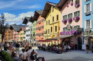 a group of people walking down a street with buildings at BELLE KITZ PURE im Zentrum by Belle Stay in Kitzbühel