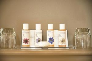 a group of four bottles of moisturizers on a shelf at The Westleton Crown in Westleton