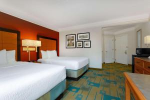 a hotel room with two beds and a television at La Quinta by Wyndham Lakeland West in Lakeland +20 photos