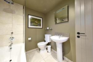 a bathroom with a toilet and a sink and a shower at The Westleton Crown in Westleton
