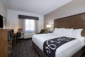 a hotel room with a large bed and a television at La Quinta by Wyndham Fairbanks Airport in Fairbanks