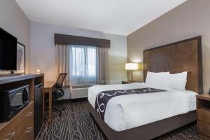 a hotel room with a bed and a flat screen tv at La Quinta by Wyndham Fairbanks Airport in Fairbanks +24 photos