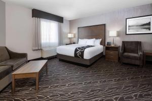 a hotel room with a bed and a couch at La Quinta by Wyndham Fairbanks Airport in Fairbanks