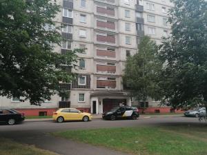 two cars parked in front of a large building at 15 minutes from the Beach and city Center 7 minutes from the airport in Riga