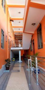 a hallway of an orange building with a staircase at Kyato Hotel in Kasanda
