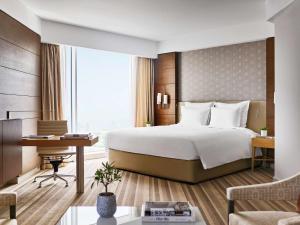 a hotel room with a bed and a desk at Pullman Doha West Bay in Doha +37 photos